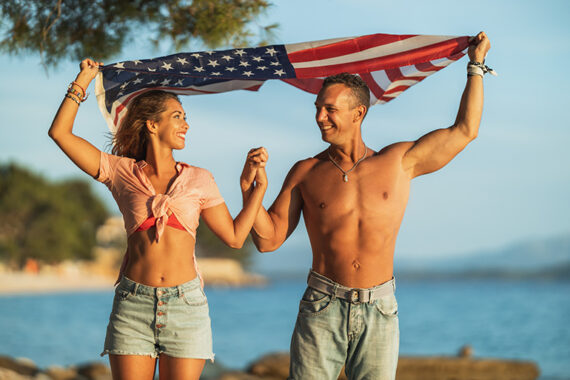 Happy Couple Holds American Flag