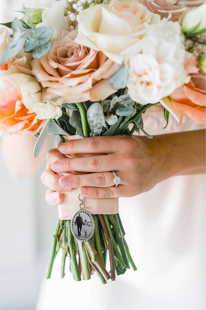 Bridal bouquet with memory charms and peach roses.