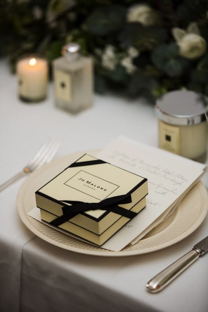 Personalized luxury wedding favor with Jo Malone gift box and candlelight.