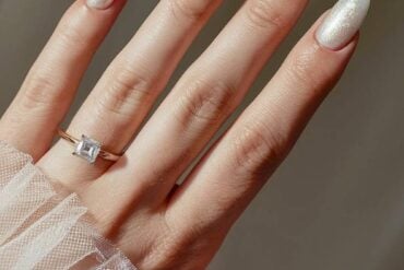 White luxury wedding nails with pearl shimmer finish.