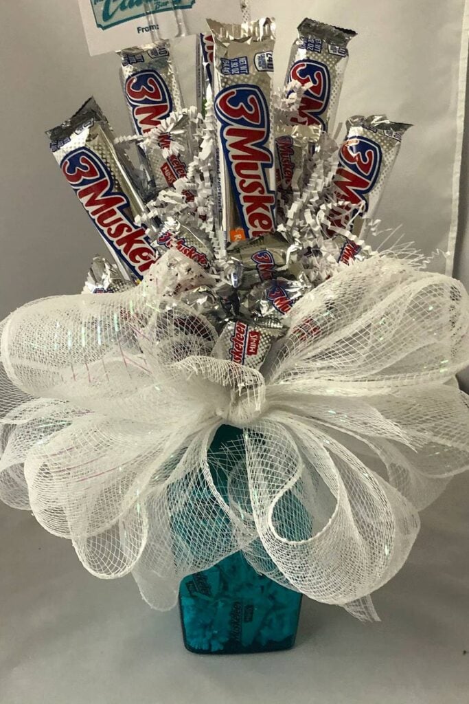 3 Musketeers candy bouquet with silver and white design.