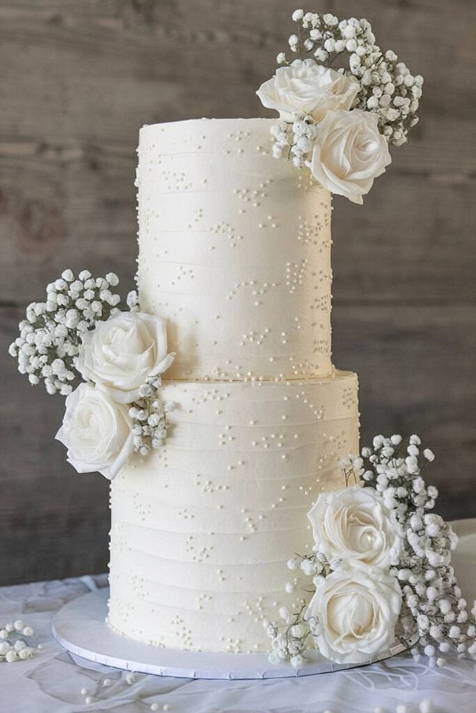 Baby’s breath and rose wedding cake with textured buttercream.