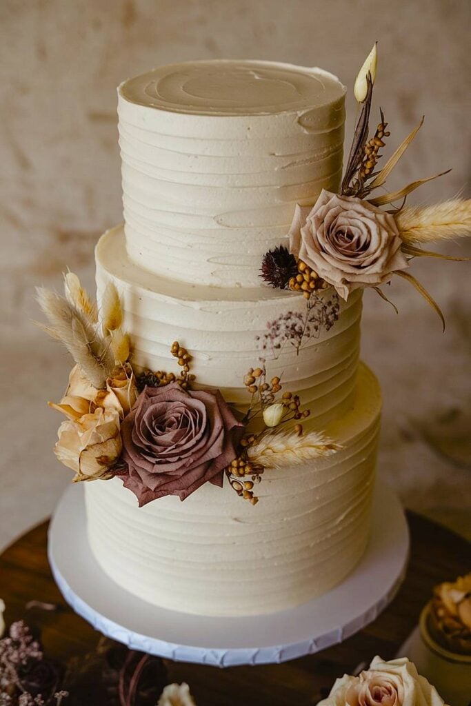 Boho wedding cake with dried flowers and textured buttercream.