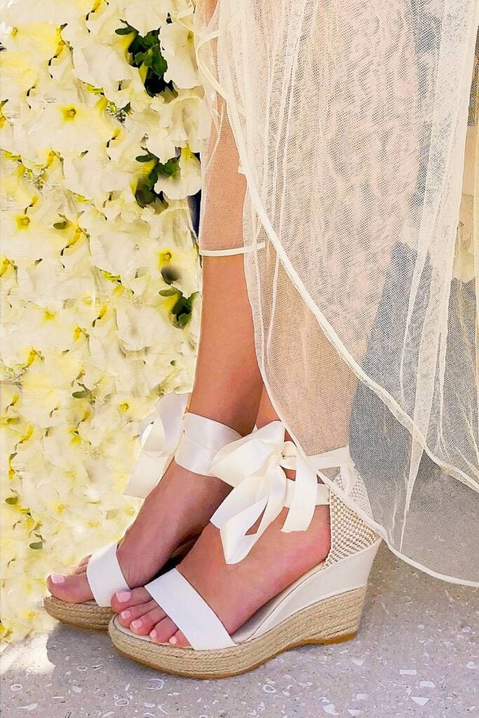 Ribbon-tie white wedge heels for a beach wedding.
