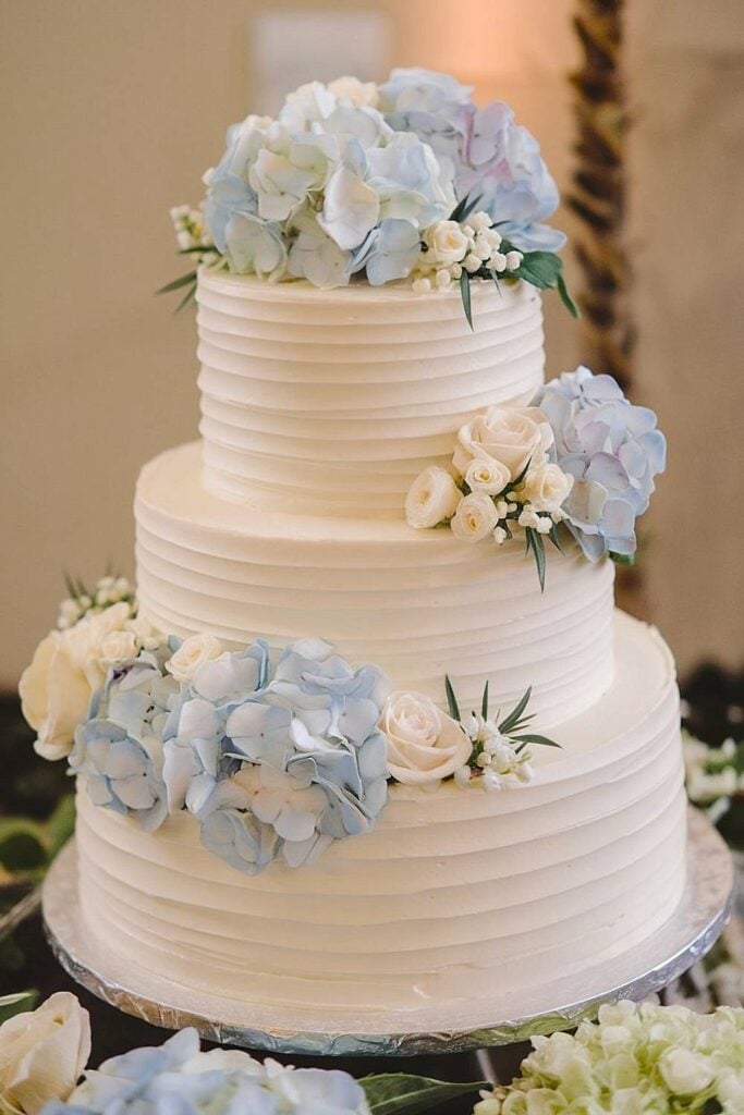 Hydrangea and rose wedding cake with ribbed buttercream.