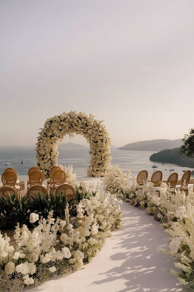 Luxurious beach wedding floral aisle with white roses.