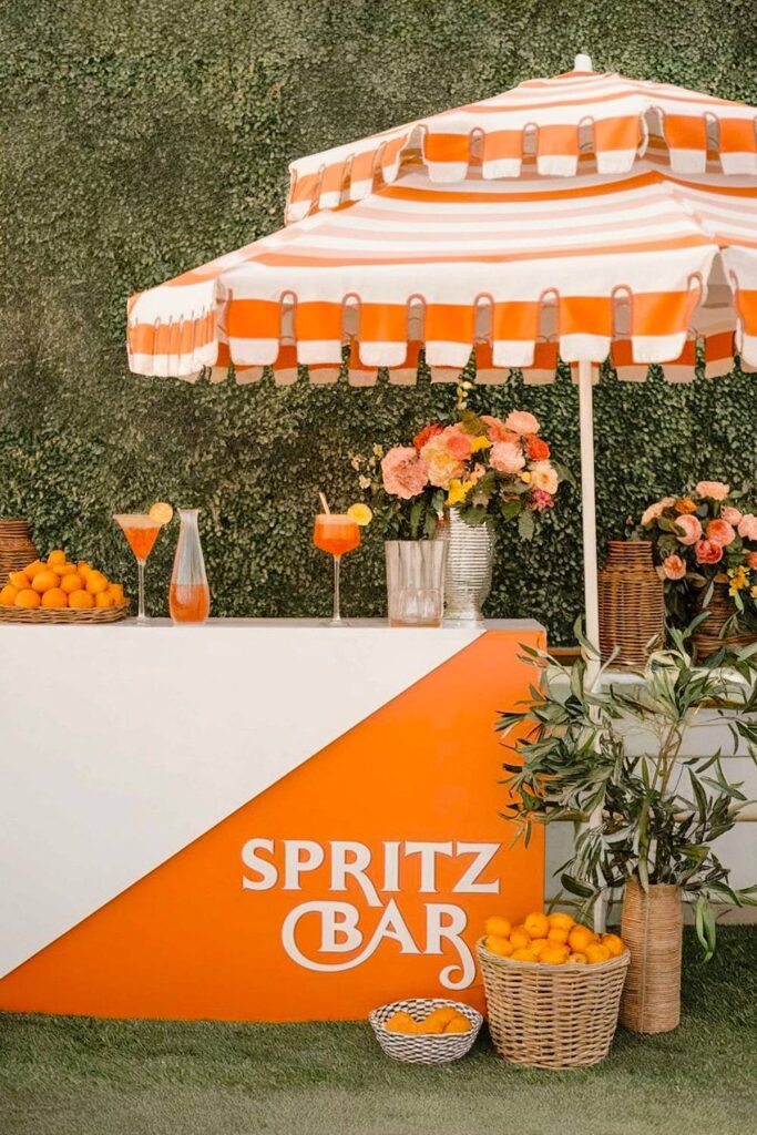 Aperol spritz aesthetic bachelorette party with orange decor and bar.