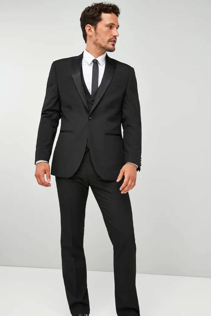 Black groomsmen suit with satin lapel formal wedding attire.