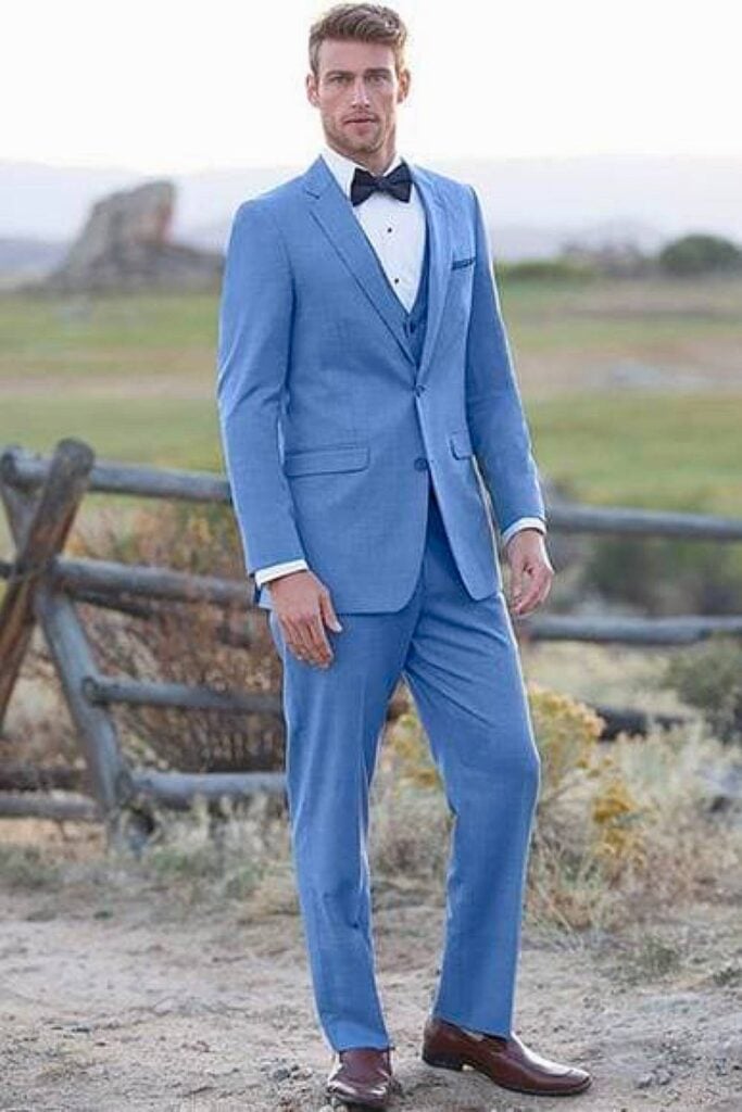 Dusty blue groomsmen suit with bow tie wedding look.