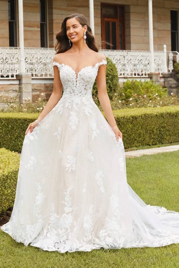 Lace fairytale wedding dress with off shoulder neckline.