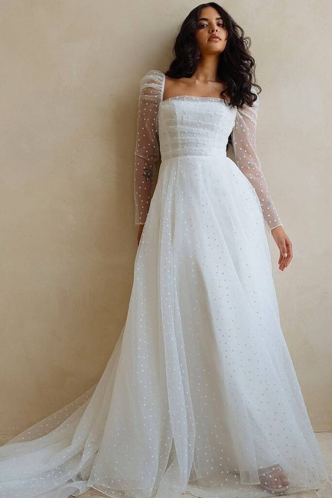 Long sleeve boho wedding dress with sheer polka dot sleeves.