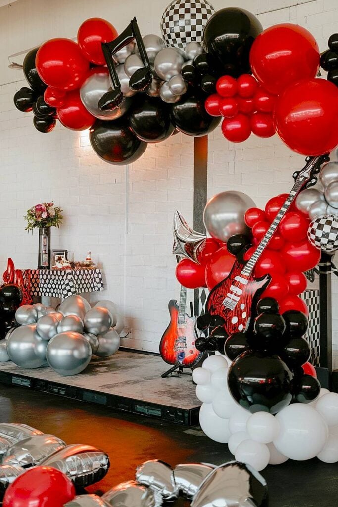 Rock n roll bachelorette party with guitar decor and balloon arch.