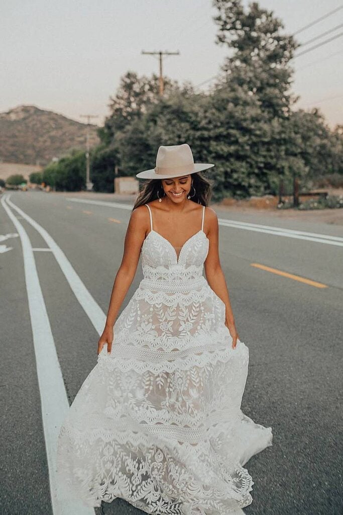 Spaghetti strap boho wedding dress with lace details.