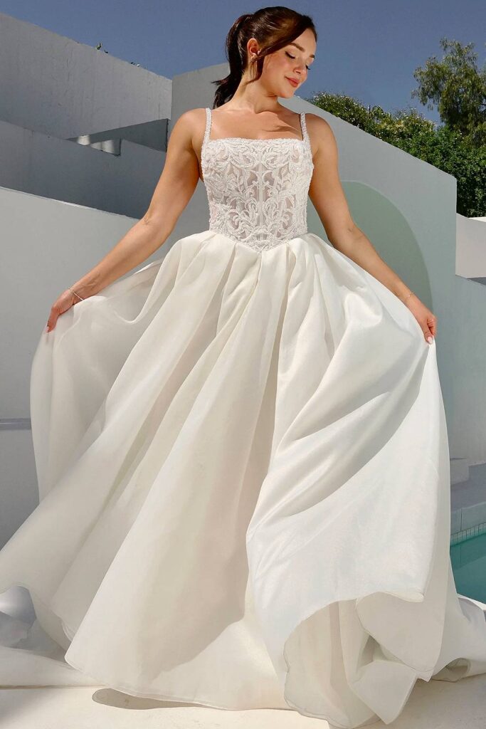 Square neck fairytale wedding dress with structured bodice and satin skirt.