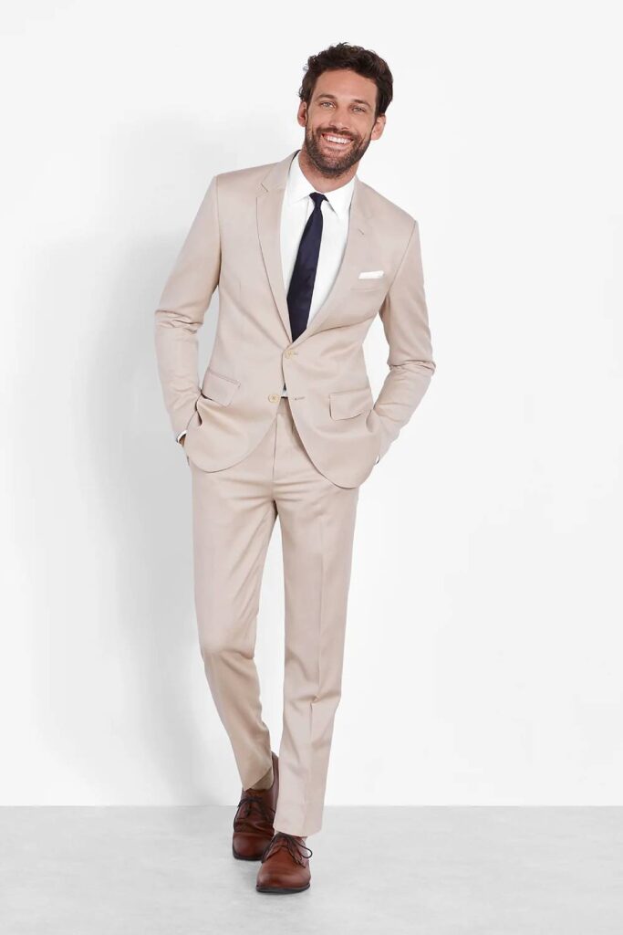 Tan groomsmen suit summer wedding attire.