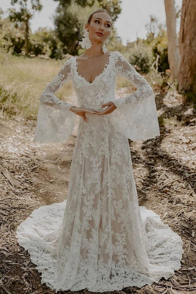 Trumpet sleeve boho wedding dress with lace details.
