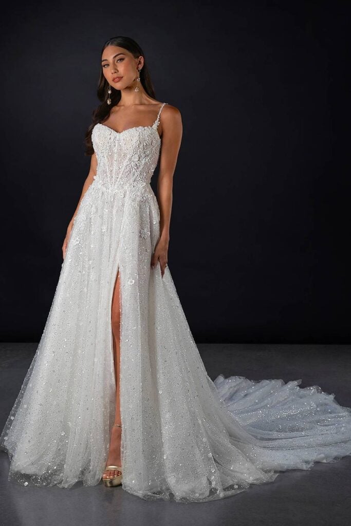 Sparkly fairytale wedding dress with corset bodice and slit.