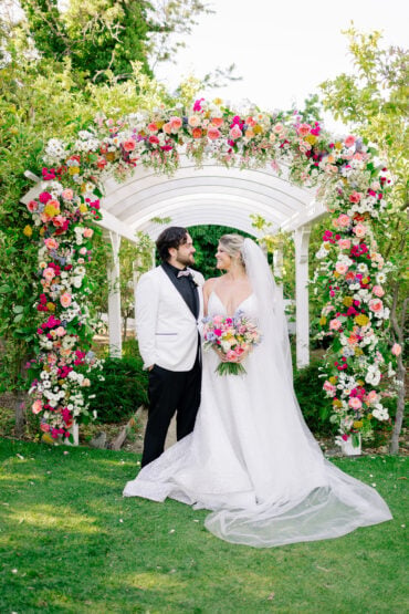 Heather and Jaykob wedding at the Madonna Inn under floral arch