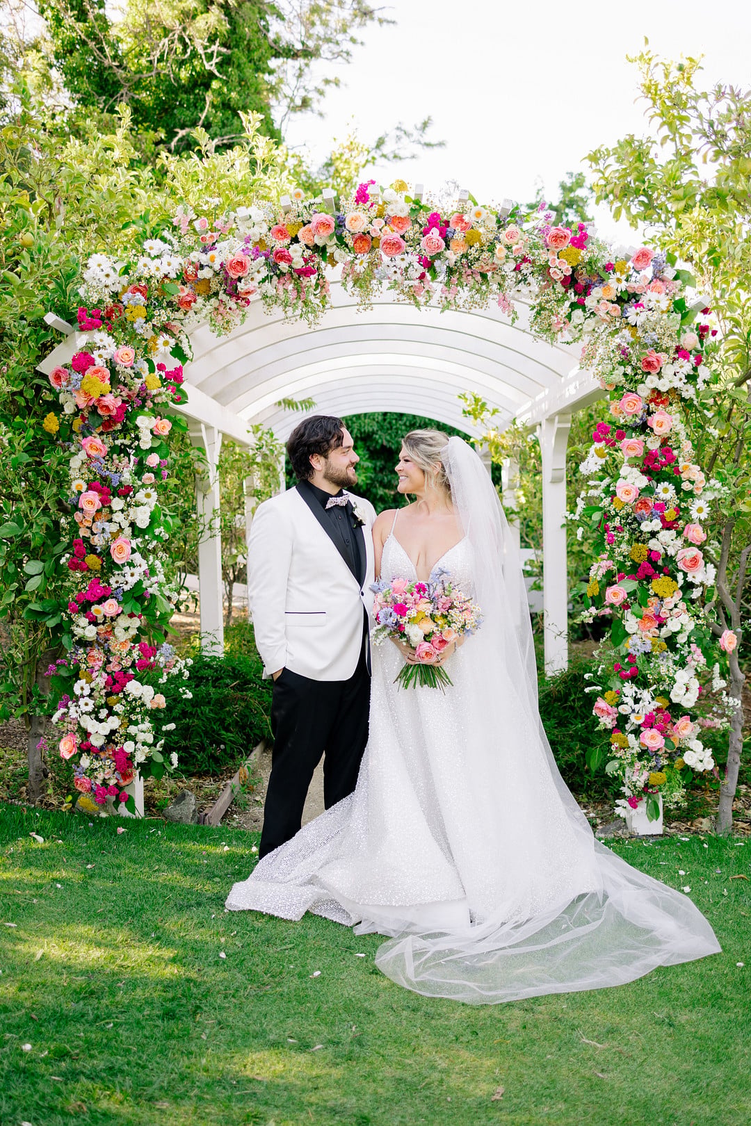 Heather and Jaykob under the floral arch