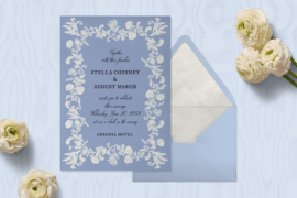 Blue and white floral wedding invitation from Paperless Post's 2026 collection with matching envelope and white ranunculus