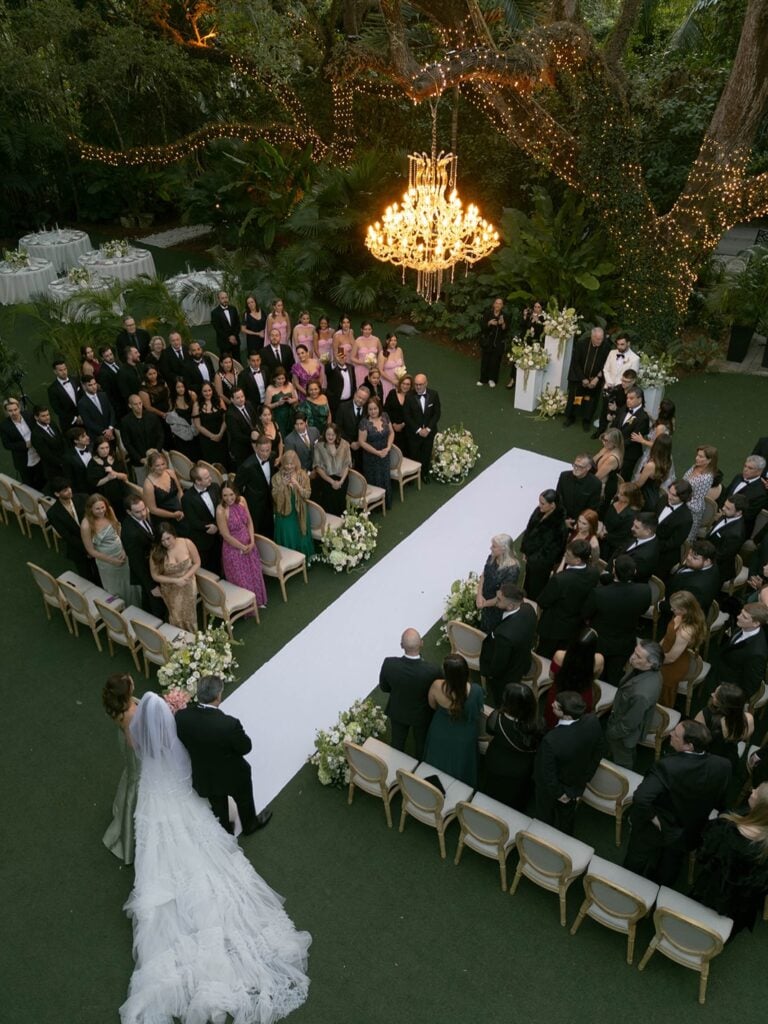 Aerial view of Sunken Gardens St. Petersburg wedding ceremony with chandeliers, lush tropical gardens and garden aisle