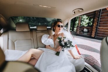 bride in limo with sunglasses