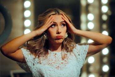 bride wearing white dress looking worried