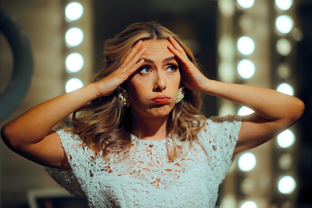 bride wearing white dress looking worried