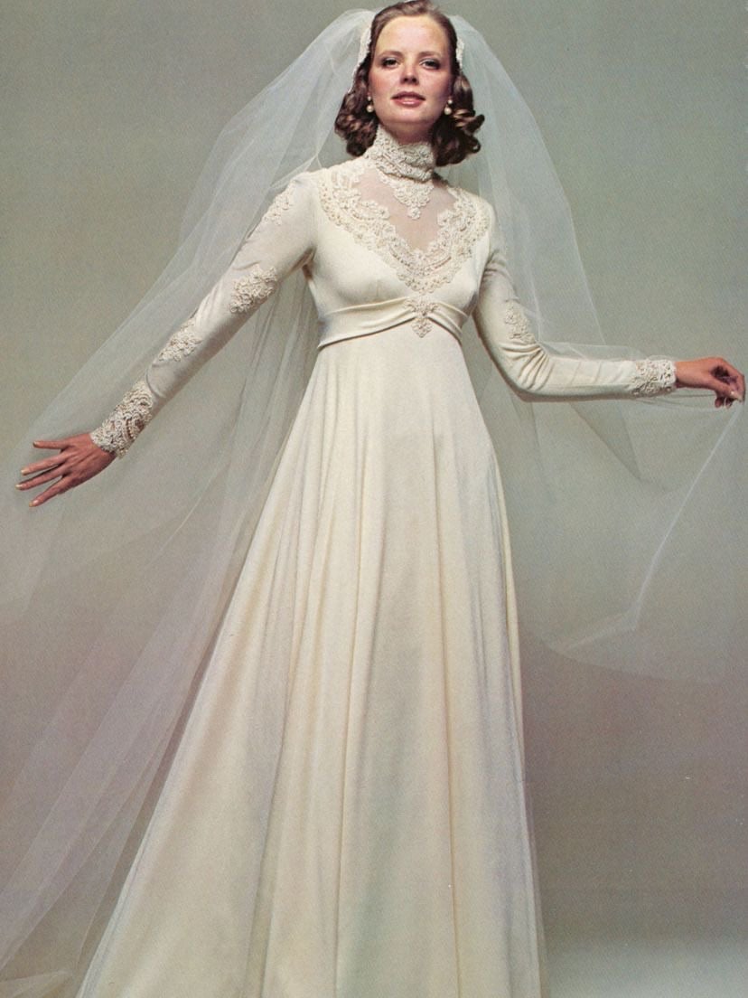 1970s ivory jersey wedding gown with a high lace collar and empire waist
