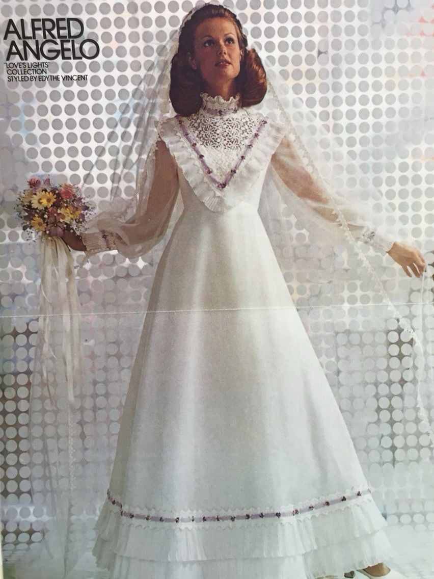 Alfred Angelo Love's Lights 1970s gown with a crochet lace bib and floral trim
