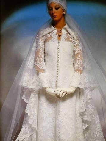 1970s bride in a full lace cape layered over a lace gown with long gloves