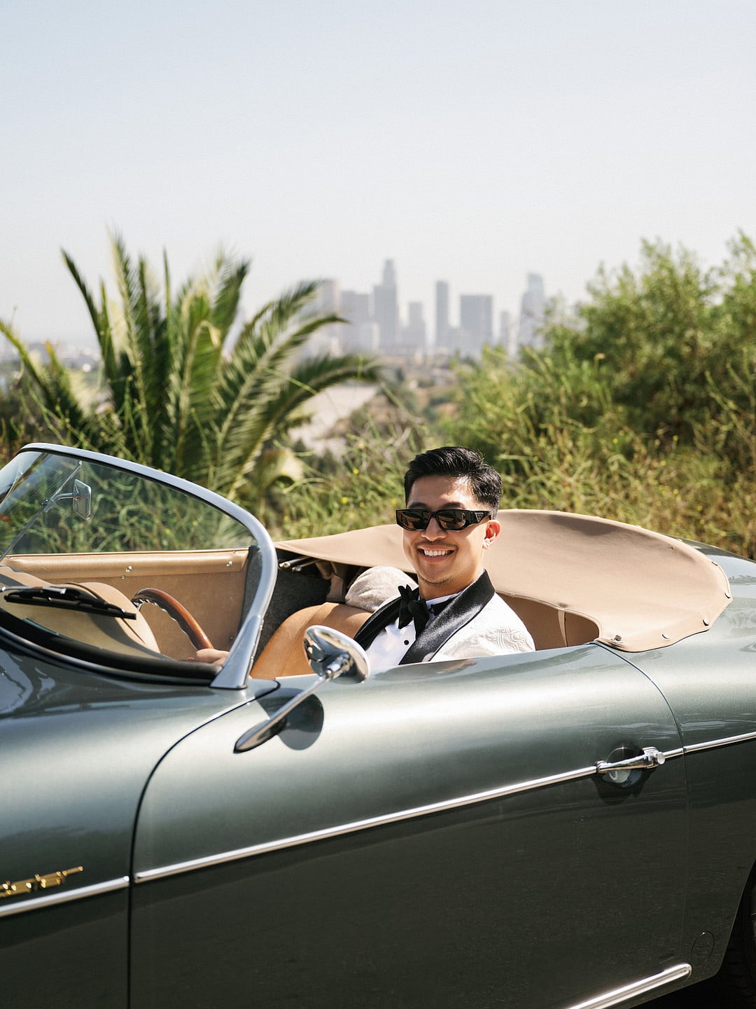 The groom in the vintage convertible