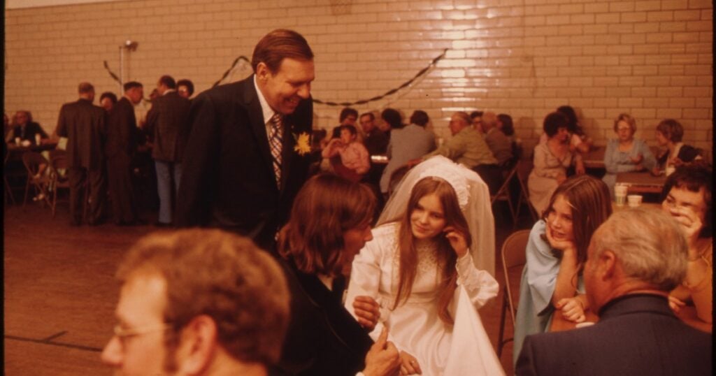 A 1970s wedding reception, the bride greeting guests at the wedding dance