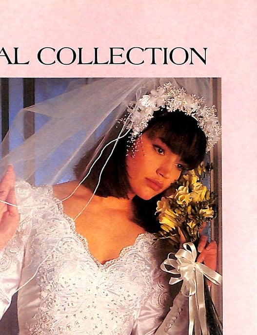 1988 Alfred Angelo ad, bride with full bangs and a halo of baby's breath holding a bouquet