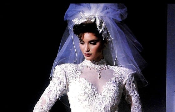 1988 Eve of Milady Ecstasies two-page ad, bride with glam swept-up hair and pouf against a dramatic blue-lit set