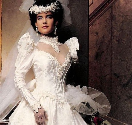 1988 Zurc Princess Collection ad, bride with dark curly updo under a floral crown headpiece