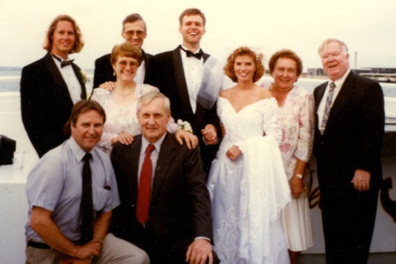 1996 wedding party group photo with bride in classic puff-sleeve wedding dress