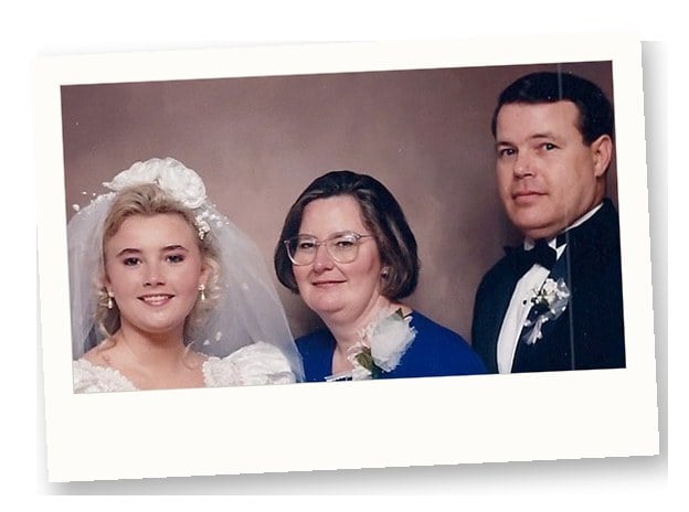 1990s bride in headpiece and veil posing for a formal portrait
