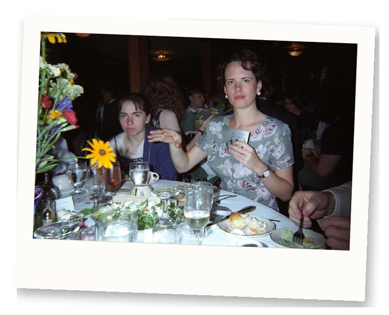 Guests seated at a 1990s wedding reception table