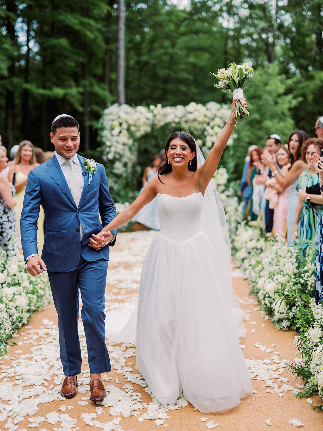 Quinn raising her arm in celebration walking back up the aisle