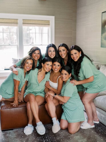 Quinn and her bridesmaids laughing together in green robes before the ceremony