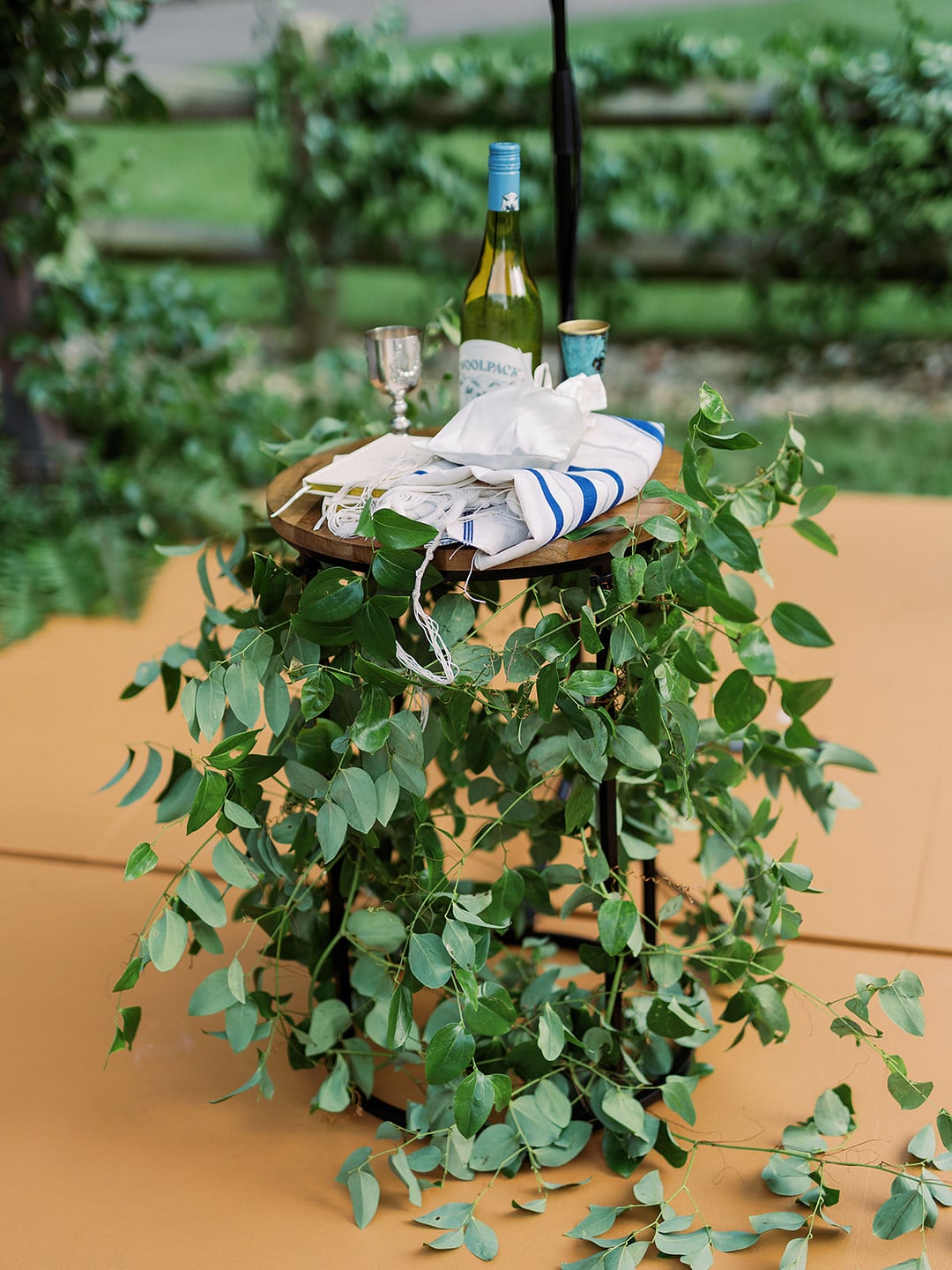 Hanging greenery and florals decorating the ceremony chuppah