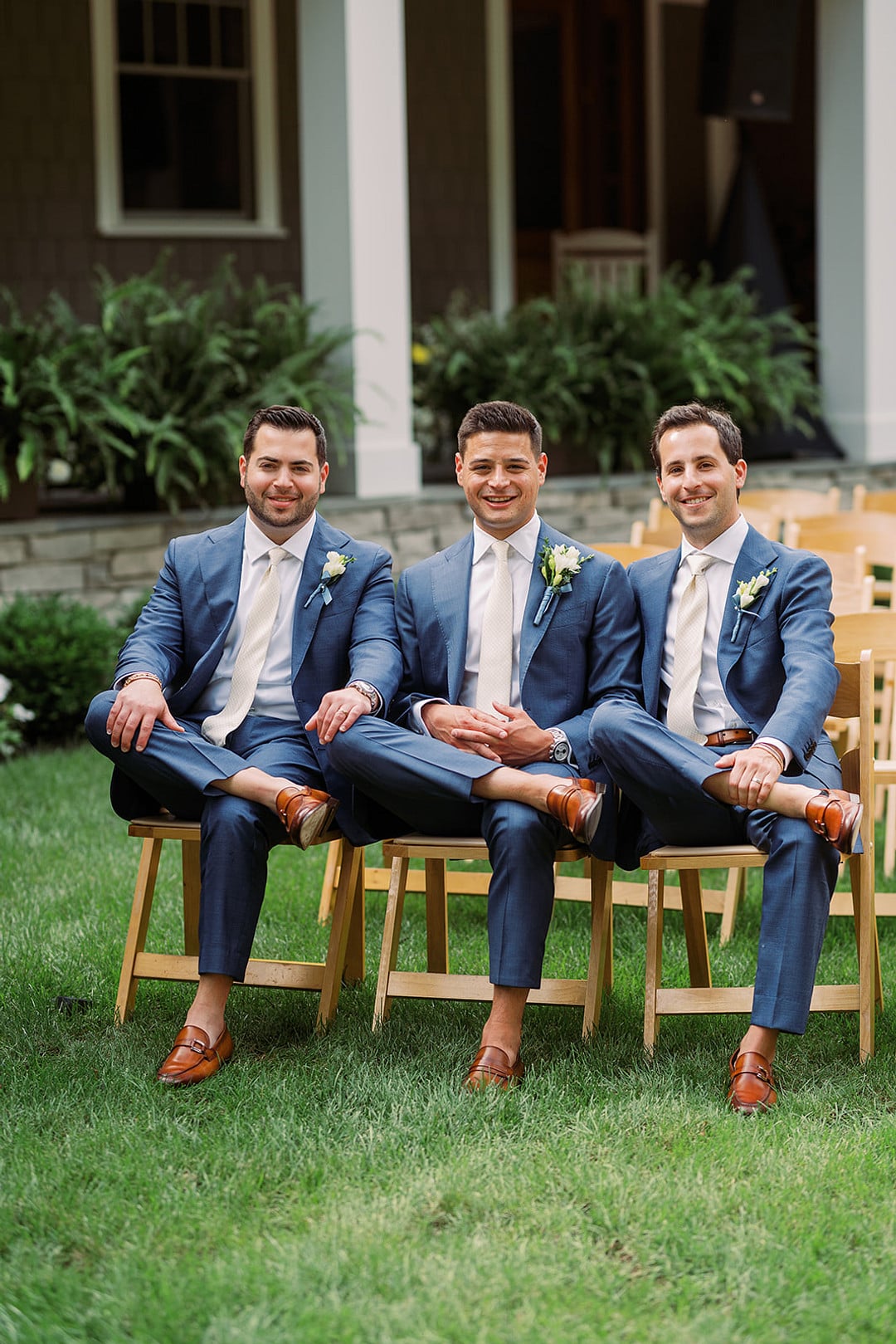 Michael and his groomsmen in blue suits on the lawn