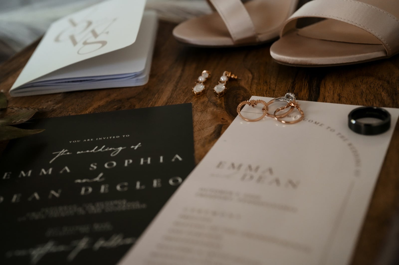 Wedding invitation suite flat lay with rings, earrings, and bridal shoes