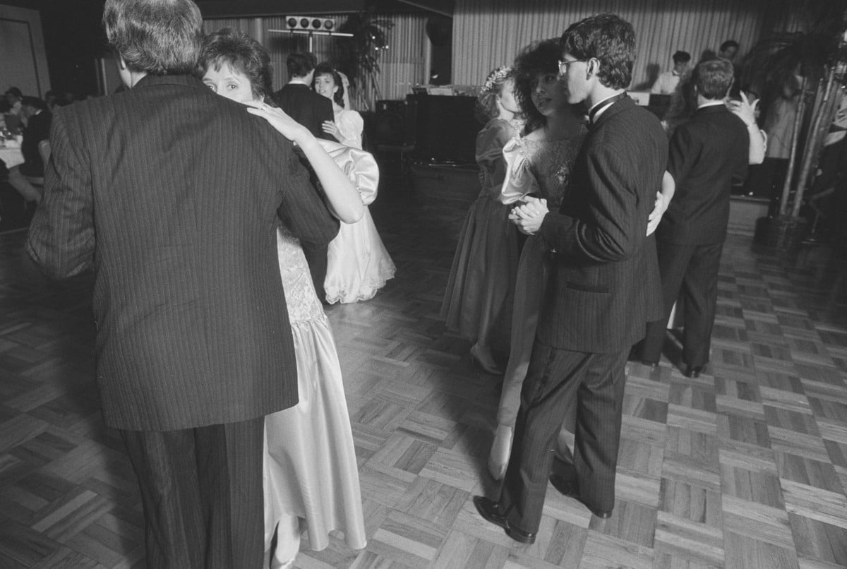 A packed dance floor of couples slow dancing at a 1989 wedding reception