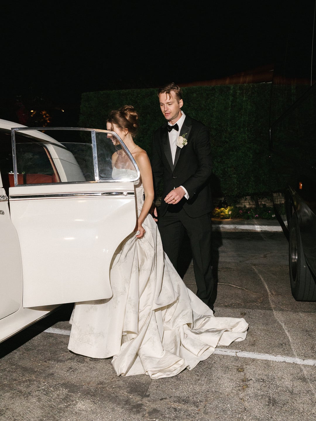 Baylee and Avery leaving their reception with a vintage 1961 Bentley