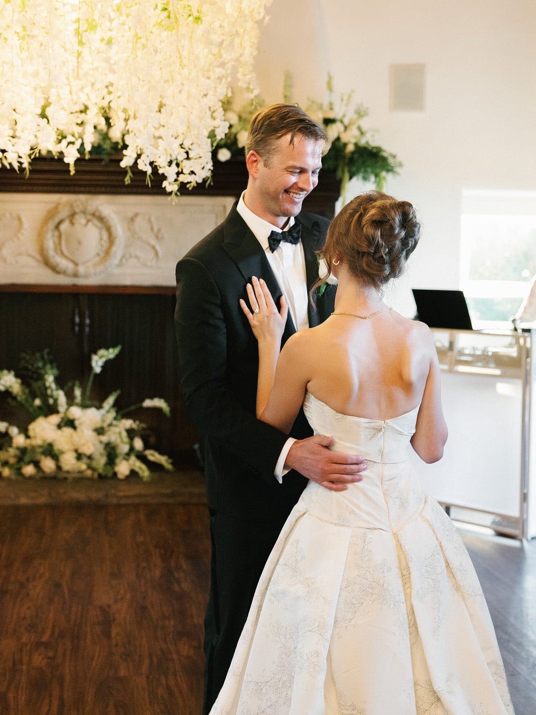 Baylee and Avery share their first dance under white wisteria florals