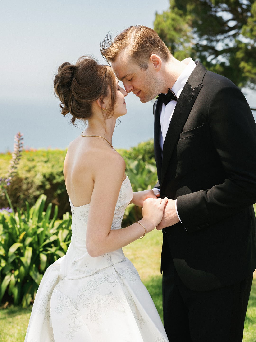 Baylee and Avery touch foreheads during their first look in the La Venta Inn gardens