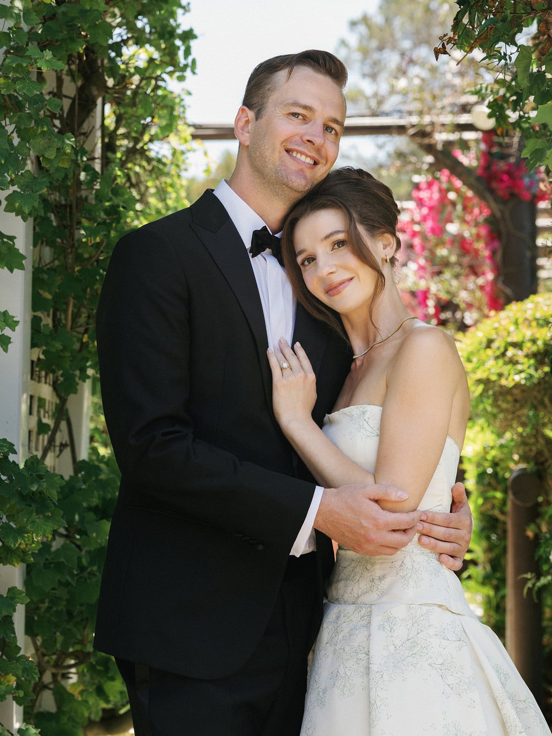 Baylee and Avery embrace in the gardens at La Venta Inn after their Palos Verdes wedding ceremony