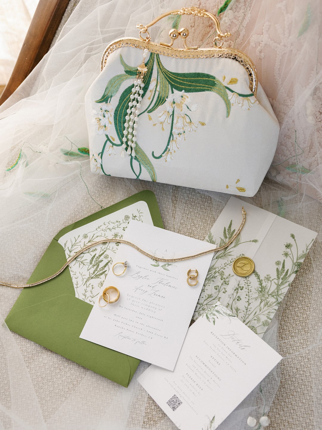 Embroidered lily of the valley handbag with the green and ivory invitation suite
